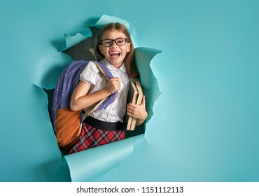 Back To School And Happy Time! Cute Industrious Child Is Breaking Through Color Paper Wall. Kid With Backpack. Girl Ready To Study.