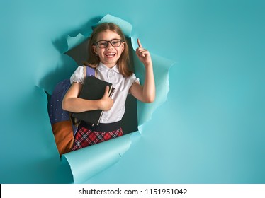 Back To School And Happy Time! Cute Industrious Child Is Breaking Through Color Paper Wall. Kid With Backpack. Girl Ready To Study.