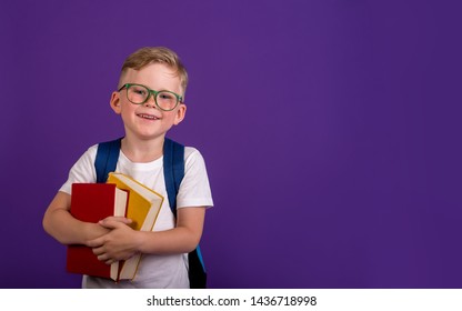 Back To School. Image Of Happy Pupil From Primary School With Books And Bag On Colored Wall. 