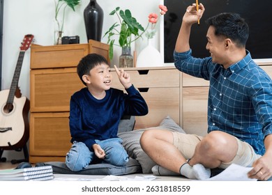 Back to School and Interactive Learning. A father and son engage in fun educational activities at home.