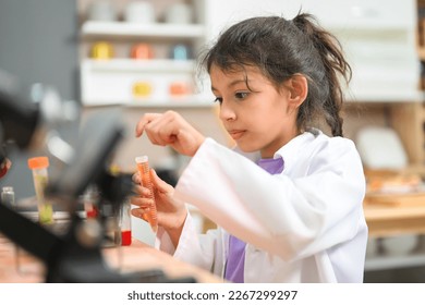 Back to school, Kids education knowledge, Child in classroom at school, Kid dressed Science lab coat. Science concept - Powered by Shutterstock