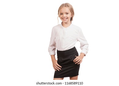 Back to school. Lovely nine year old schoolgirl in a shirt and a skirt posing isolated on white - Powered by Shutterstock