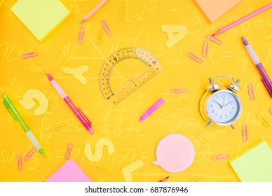 back to school or office styed pattern with multicolored school supplies on yellow back ground with math formulas