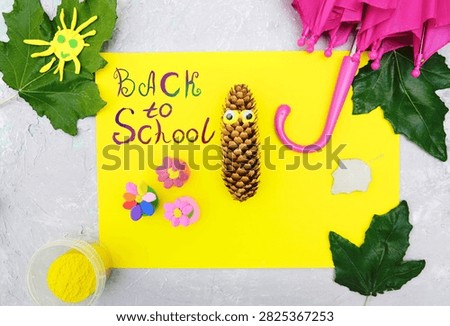 Back to School paintbrush text. Child getting ready to create a greeting card.  On the table typical crafting materials. Showcases creativity, DIY, and craft activities. School supplies, art projects, educational content. Educational content about arts and crafts.