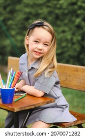 Back To School Portrait Image Of Little Girl Wearing Uniform Sitting At Old Style Desk