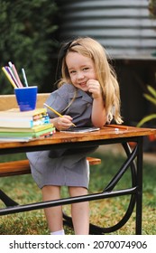 Back To School Portrait Image Of Little Girl Wearing Uniform Sitting At Old Style Desk