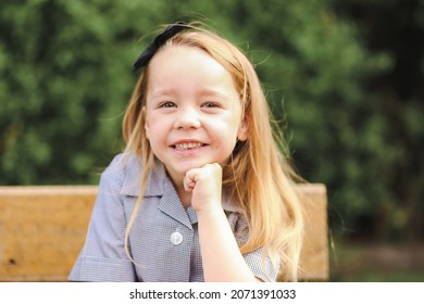 Back To School Portrait Image Of Little Girl Wearing Uniform Sitting At Old Style Desk