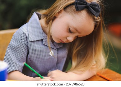 Back To School Portrait Image Of Little Girl Wearing Uniform Sitting At Old Style Desk