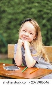 Back To School Portrait Image Of Little Girl Wearing Uniform Sitting At Old Style Desk