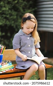 Back To School Portrait Image Of Little Girl Wearing Uniform Sitting At Old Style Desk