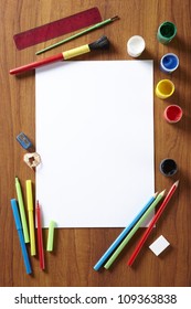 Back To School Pupils Art Pad Paints Pencils And Pens On Wooden School Desk From Above