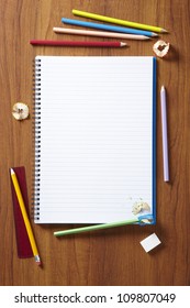 Back To School Pupils Art Pencils And Pad On Wooden School Desk From Above