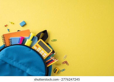 Back to school scene with a blue backpack packed with colorful notebook, pencil, calculator and stationery on a bright yellow background