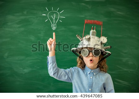 Back to school. Schoolchild with virtual reality headset. Child in class. Funny kid against blackboard. Nerd kid having fun. Geek child with VR glasses. Innovation technology and education concept