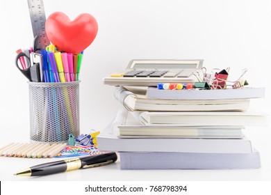 Back To School Supplies. Items For The School On Table. Pile Of Notebooks And Pencils On The Desk For Elementary School.
Office Accessories Material Isolated On White Background.
Notebook, Paper, Calc