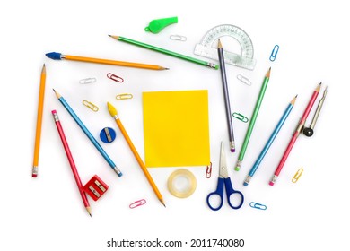 Back To School. School Supplies ( Yellow Sheet, Pencil, Scissors, Sharpener, Clips, Crayons ) On A White Background. Top View, Flat Lay