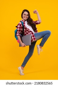 Back to school. Teenager schoolgirl hold notebook laptop. School children on isolated yellow studio background. Run and jump, jumping kid. - Shutterstock ID 2180832565