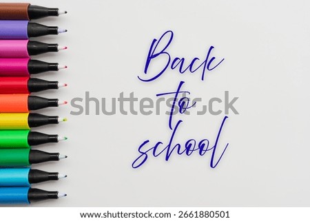 Back to school text and Black fineliners on white backgound. Multicolored Markers. education concept