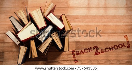 Back to school text over white background against various type of books arranged