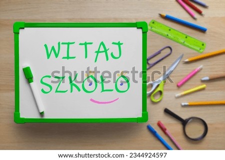 Back to School text in Polish. Whiteboard with inscription against the background of school supplies.  Top view on flat lay. concept of new school year at school in Poland, Learning Polish language