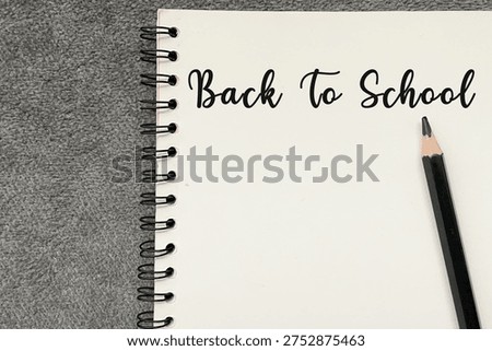 Back to school text written on notebook page, education concept for new academic year and learning preparation.