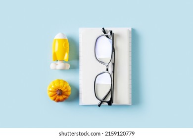 Back to school theme with white and yellow schools tools and rocket on blue background, knolling flat lay, top view, copy space