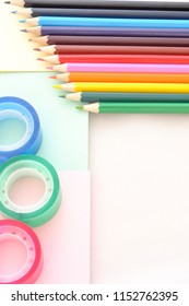 Back To School, Top View Of Desk With Colored Pencils, Adhesive Tape And Notes, Copy Space, Vertical Background