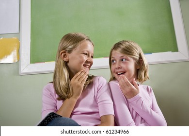 Back To School - Two 8 Year Old Girls In Classroom By Chalkboard