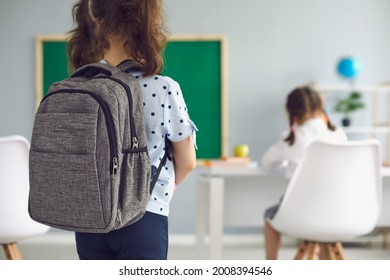 Back To School. Back View. Schoolgirl With A Backpack In The Classroom. Education.Teaching Children Kids Education.