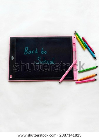 back to school written on an LCD writing tablet 