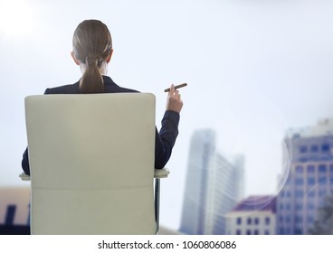 Back of seated business woman smoking cigar against blurry buildings and flare - Powered by Shutterstock