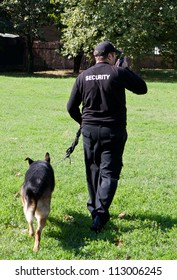 Back Of A Security Guard With A Dog