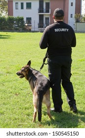 Back Of A Security Guard With A Dog