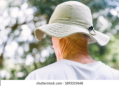 Back Of Senior Man's Head Wearing Protective Sun Hat Outside