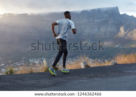 Similar – Image, Stock Photo runner running across the field with his dog