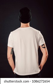Back Shot Of Handsome Bearded Man With Fresh Haircut And Tattooed Arms Posing On Isolated Wall Mockup In White Simple Blank Tshirt Ready For Designs