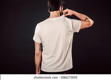 Back Shot Of Handsome Bearded Man With Fresh Haircut And Tattooed Arms Posing On Isolated Wall Mockup In White Simple Blank Tshirt Ready For Designs