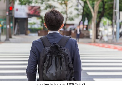 Back Shot Of Young Business Man With Backpack Bag During Early Morning