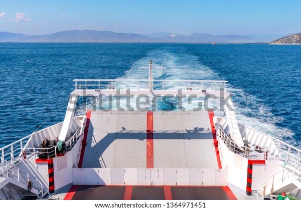 Back side of big ferry boat in the Mediterranean sea\
with blue sky