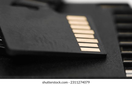 Back side of black SD memory card. Computer equipment. Memory card backup - Shutterstock ID 2311274079