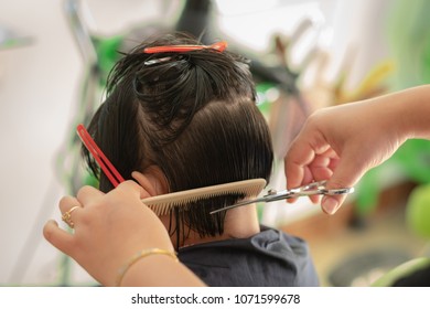 Back Side Of A Girl Hair Cut In Barber Salon