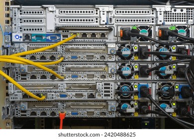 Back side of network servers in the rack with cable connections.