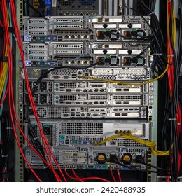 Back side of network servers in the rack with cable connections.