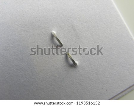 Back side staple on white papers