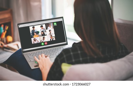 Back Side View of Asian Business Woman Meeting with Multiethnic Business People and VDO Conference Live Streaming in Work from Home Concept - Social Distancing in Coronavirus(Covid-19) Outbreak
