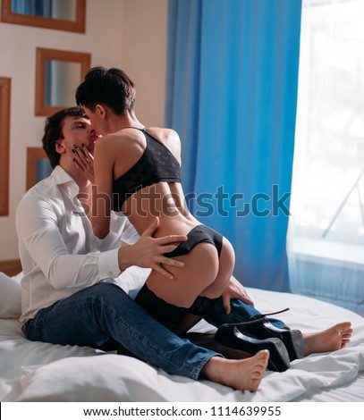 Back side view of couple about to have sex, booty fit buttocks of lady, man caressing her ass, gentle with hands and fingers, embracing, hugging