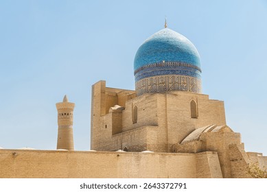 Back side view of the Kalan Mosque at Po-i-Kalan complex in Bukhara, Uzbekistan. The ensemble is a popular tourist attraction of Central Asia.