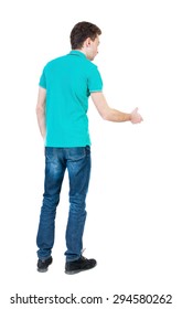 Back Side View Of Man  In Shirt Handshake.   Isolated Over White Background.  The Guy In A Stylish T-shirt Extends His Hand In Greeting.