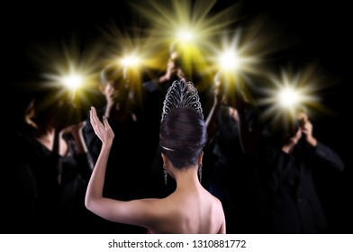 Back side view of Miss Pageant beauty contest with Silver Diamond Crown wave hand to many Photographers who shoot photo image to celebrity at red carpet event, and flash fire light came out copy space - Shutterstock ID 1310881772