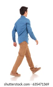 Back Side View Of A Walking Young Casual Man On White Background